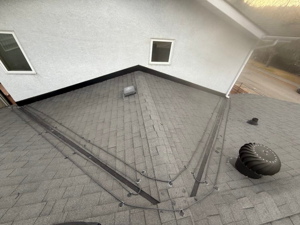 Professional heat tape installation covering multiple intersecting roof valleys to ensure proper winter drainage and prevent ice damming.