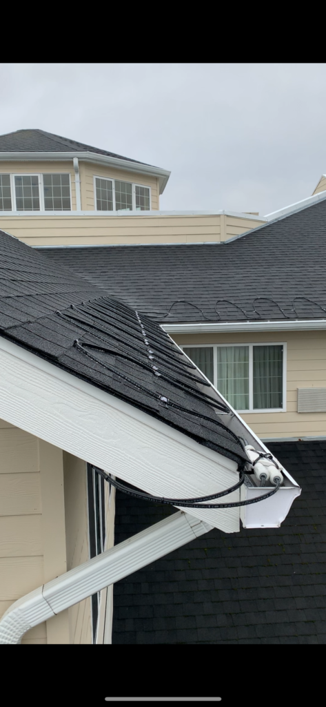 Symmetrical serpentine roof edge heating cable layout on a front entry residential gable.