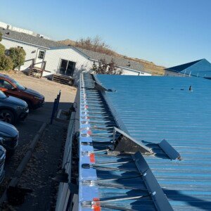 Industrial roof heating cables and gutter heat tracing on a sloped metal commercial building in Calgary.