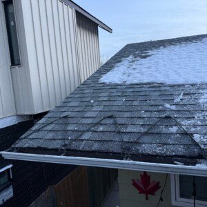 Serpentine pattern roof edge de-icing cable installation on a residential asphalt shingle roof in Calgary.