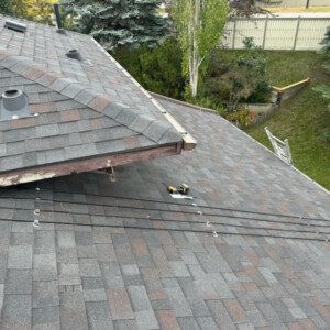 Residential multi-level shingle roof preparation for a local Calgary heat cable installation.