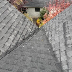 Residential roof valley heat trace cable installation designed to prevent ice buildup on asphalt shingles.