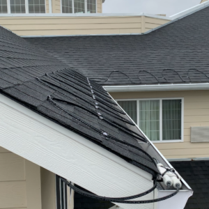 Symmetrical serpentine roof edge heating cable layout on a front entry residential gable.
