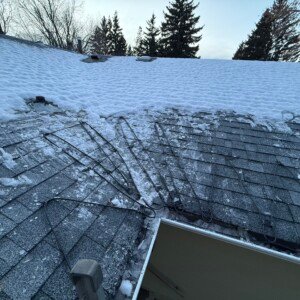Self-regulating heat trace cable routed through a critical roof valley and gutter system to prevent winter ice buildup.